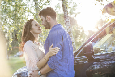 Couple embracing and kissing while on a road trip - WESTF22394