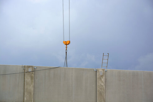 Crane and ladder behind a concrete wall - AXF00785