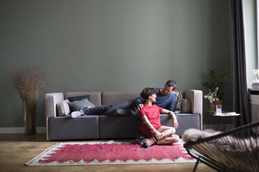 Couple relaxing together in the living room - RBF05456