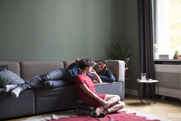 Couple relaxing together in the living room - RBF05457