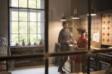 Couple talking together in the kitchen - RBF05470