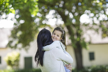 Mother carrying daughter in garden - ZEF12340