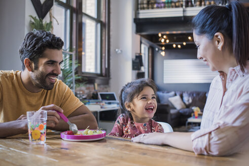 Mother and father feeding their little daughter in kitchen - WESTF22449