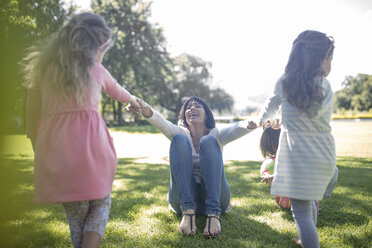 Two girls playing with their momther in park - ZEF12346