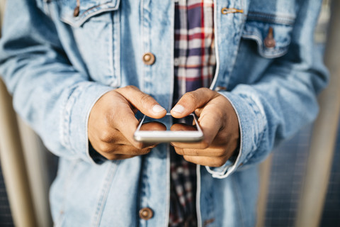 Man's hands text messaging stock photo