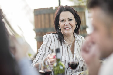 Smiling senior woman at family lunch in garden - ZEF12374