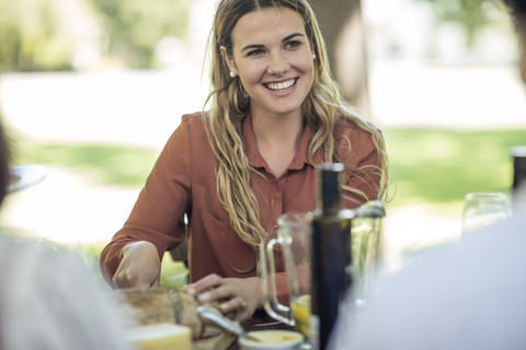 Smiling woman at family lunch in garden stock photo