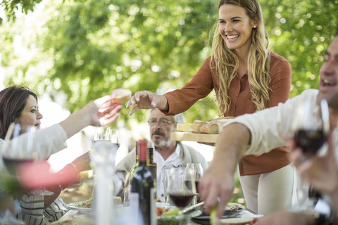 Smiling woman at family lunch in garden stock photo