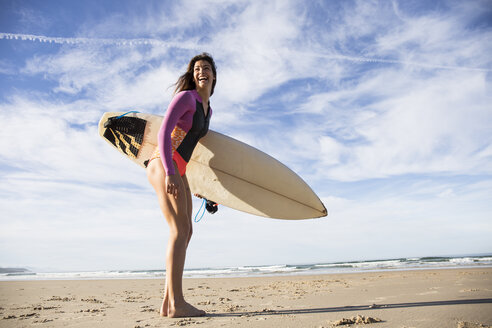 Happy woman with surfboard on the beach - ABZF01734