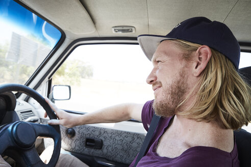 Blond man driving car - SRYF00185