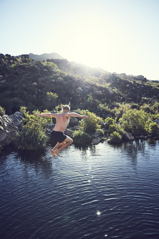 South Africa, Porterville, Beaverlac, man jumping into water stock photo