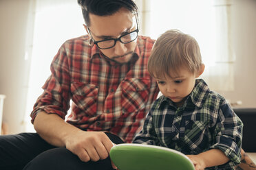 Father and son with toy laptop - ZEDF00478