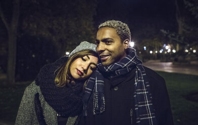 Portrait of young couple at park in winter - DAPF00539