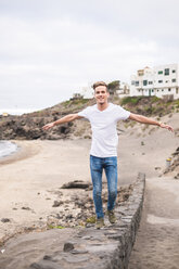 Young man balancing on a wall - SIPF01273