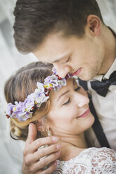 Close-up of bride and groom embracing - ASCF00692