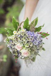 Close-up of bride holding bridal bouquet - ASCF00695
