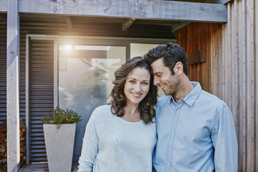 Couple standing in front of door of their home - RORF00469