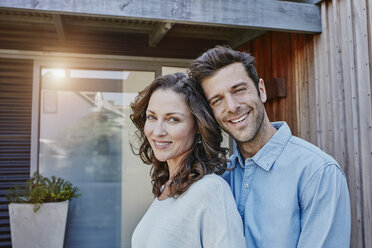 Couple standing in front of door of their home - RORF00470