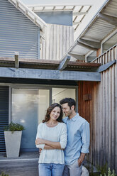 Couple standing in front of door of their home - RORF00471