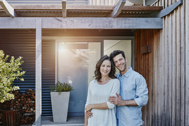 Couple standing in front of door of their home - RORF00472