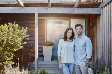 Couple standing in front of door of their home - RORF00473