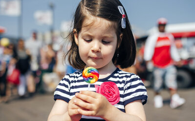 USA, New York, Coney Island, little girl with lollipop - DAPF00546