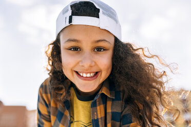 Portrait of happy girl wearing baseball cap - MGOF02809