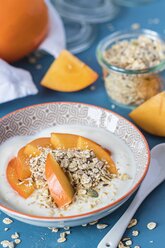 Bowl of natural yoghurt with granola and kaki - YFF00610