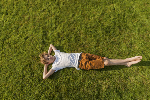 Teenage boy lying in grass - PAF01753