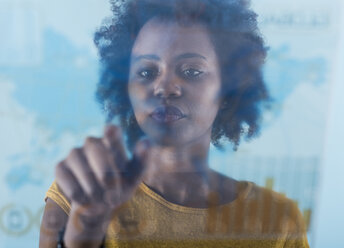 Young woman using transparent touchscreen display - UUF09780