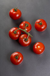 Vine tomatoes on grey ground - JUNF00766