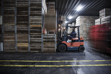 Man on forklift in factory hall - ZEF12455