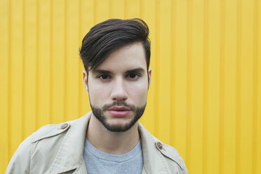 Portrait of bearded young man in front of yellow background - JUBF00182