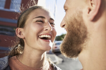 Portrait of laughing young woman face to face with her boyfriend - SRYF00202