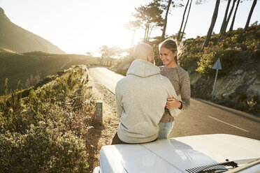 Young couple in love with car at roadside - SRYF00231