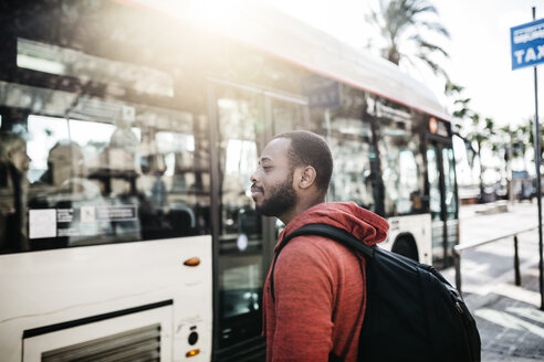 Junger Mann in der Stadt beim Warten auf den Bus - JRFF01177