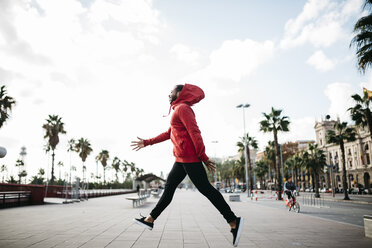 Young man in the city jumping on pavement - JRFF01181