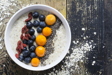 Bowl of porridge with milk, blueberries, chia, physalis and goji berries - ODF01483