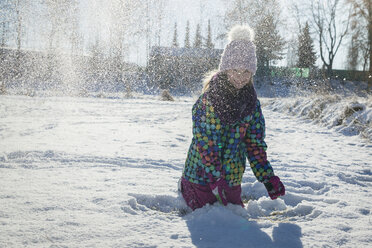 Girl throwing snow in the air - SARF03129