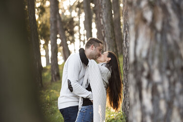 Happy couple kissing in the forest - HAPF01296