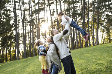 Playful family with two girls in forest - HAPF01300