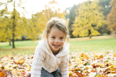 Portrait of happy girl in autumn leaves - HAPF01320