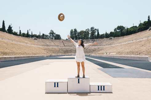 Greece, Athens, woman on the podium celebrating in the Panathenaic Stadium - GEMF01420
