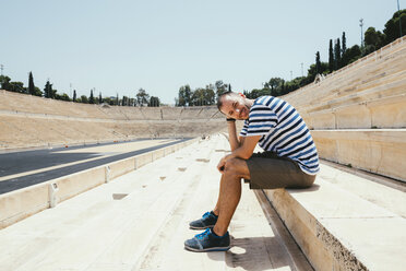 Greece, Athens, man sitting in the stands of the Panathenaic Stadium - GEMF01421
