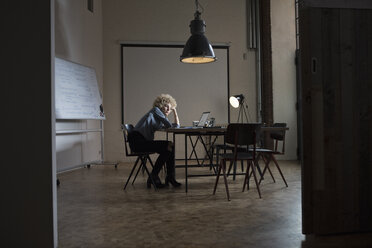 Exhausted woman in boardroom - RBF05560