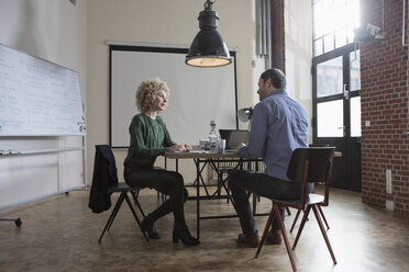 Man and woman discussing in boardroom - RBF05574