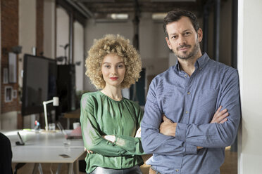 Portrait of confident man and woman in office - RBF05583