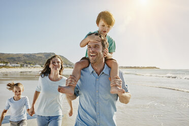 Glückliche Familie beim Spaziergang am Strand - RORF00549