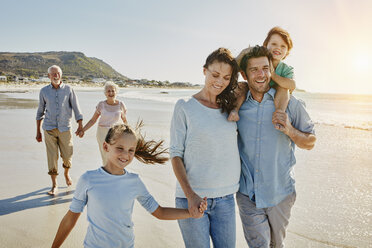 South Africa, Cape Town, three generations family strolling on the beach - RORF00552