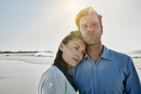 Couple on the beach at backlight stock photo